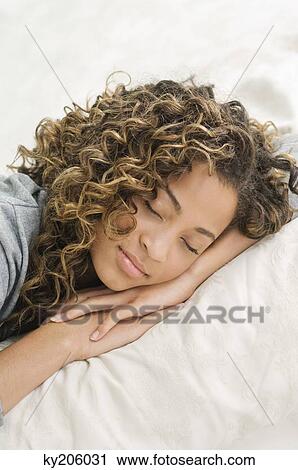 Girl sleeping on the bed View Large Photo Image Stock Image - Girl sleeping on the bed. Fotosearch