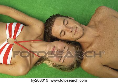Stock Photography - High angle view of a couple sunbathing. Fotosearch