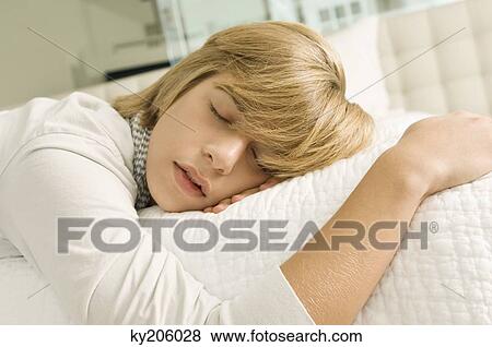 Teenage boy sleeping on the bed View Large Photo Image Stock Photo - Teenage boy sleeping on the bed. Fotosearch