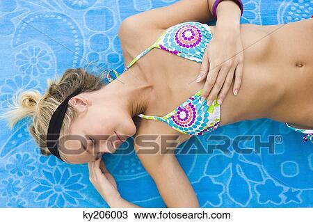 Woman lying on a sheet View Large Photo Image Stock Image - Woman lying on a sheet. Fotosearch