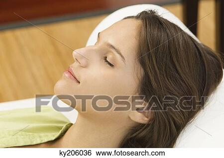 Woman lying on the bed View Large Photo Image Stock Photograph - Woman lying on the bed. Fotosearch