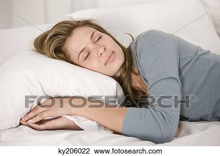 Woman sleeping on the bed View Large Photo Image Stock Image - Woman sleeping on the bed. Fotosearch