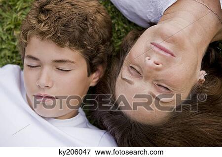 Woman with her grandson napping in a garden View Large Photo Image Stock Photo - Woman with her grandson napping in a garden. Fotosearch