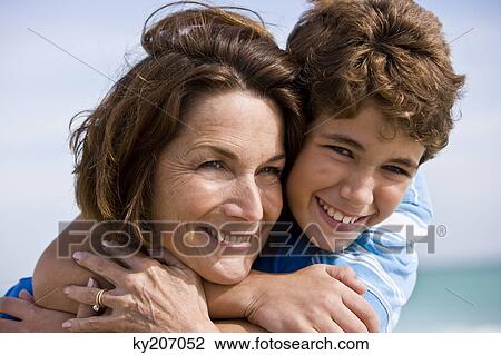 Boy hugging his grandmother View Large Photo Image Stock Image - Boy hugging his grandmother. Fotosearch