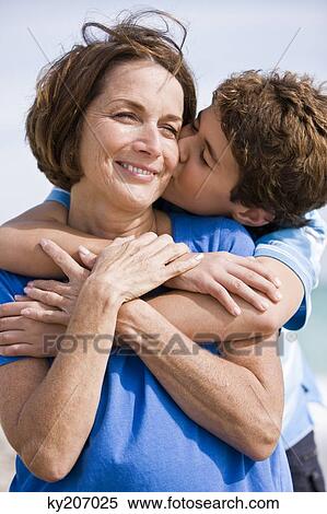 Boy kissing his grandmother View Large Photo Image Stock Photography - Boy kissing his grandmother. Fotosearch