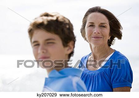 Stock Photo - Boy with his grandmother on the beach. Fotosearch