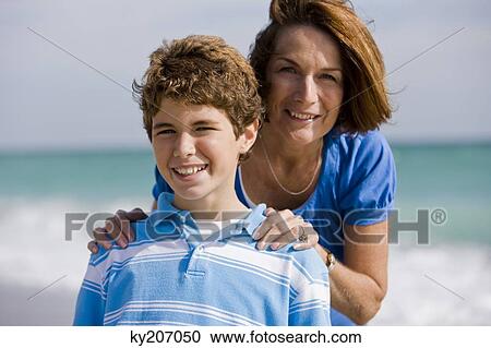Portrait of a woman smiling with her grandson View Large Photo Image Stock Image - Portrait of a woman smiling with her grandson. Fotosearch