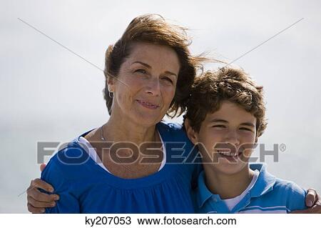 Portrait of a woman smiling with her grandson View Large Photo Image Stock Image - Portrait of a woman smiling with her grandson. Fotosearch