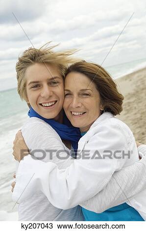 Teenage boy hugging his grandmother View Large Photo Image Stock Image - Teenage boy hugging his grandmother. Fotosearch