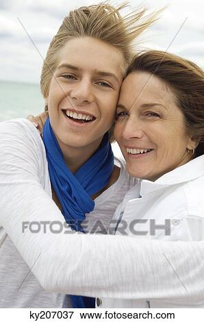 Teenage boy hugging his grandmother View Large Photo Image Stock Photo - Teenage boy hugging his grandmother. Fotosearch