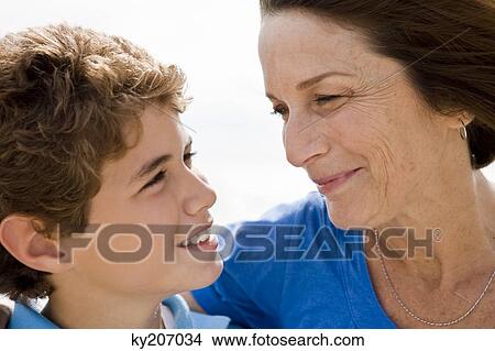 Woman and her grandson looking at each other and smiling View Large Photo Image Picture - Woman and her grandson looking at each other and smiling. Fotosearch