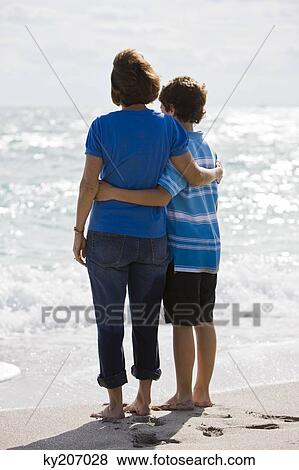 Woman with her grandson on the beach View Large Photo Image Stock Photo - Woman with her grandson on the beach. Fotosearch