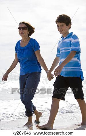 Woman with her grandson walking on the beach View Large Photo Image Stock Photography - Woman with her grandson walking on the beach. Fotosearch
