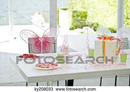 Stock Image - Birthday present and a disposable cup on a table. Fotosearch