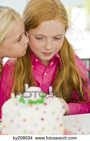 Close-up of a girl celebrating her birthday with her friend View Large Photo Image Picture - Close-up of a girl celebrating her birthday with her friend. Fotosearch