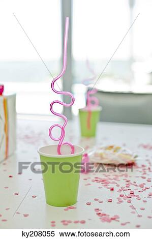 Disposable glasses with drinking straws and a birthday present on a table View Large Photo Image Stock Photography - Disposable glasses with drinking straws and a birthday present on a table. Fotosearch