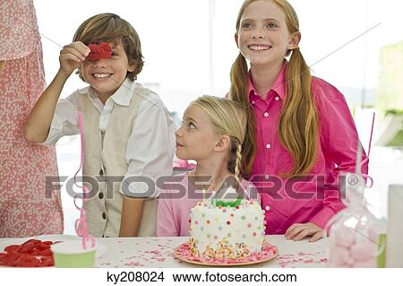 Girl celebrating her birthday with her friends View Large Photo Image Picture - Girl celebrating her birthday with her friends. Fotosearch