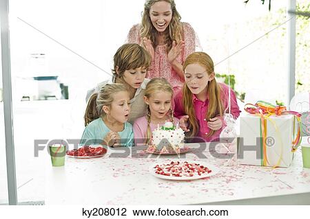 Girl celebrating her birthday with her mother and friends View Large Photo Image Stock Image - Girl celebrating her birthday with her mother and friends. Fotosearch