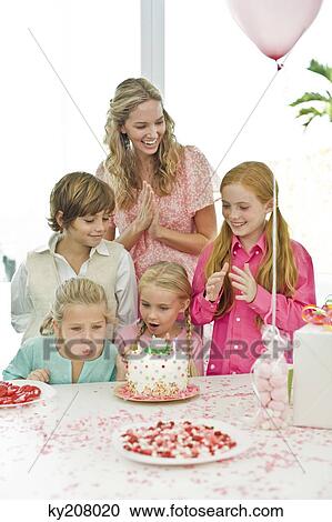 Girl celebrating her birthday with her mother and friends View Large Photo Image Stock Image - Girl celebrating her birthday with her mother and friends. Fotosearch
