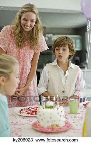 Girl celebrating her birthday with her family View Large Photo Image Stock Image - Girl celebrating her birthday with her family. Fotosearch