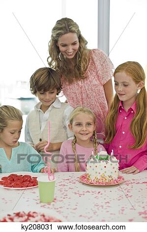 Girl celebrating her birthday with her friends View Large Photo Image Stock Image - Girl celebrating her birthday with her friends. Fotosearch