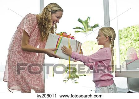 Girl giving present to her mother View Large Photo Image Stock Image - Girl giving present to her mother. Fotosearch