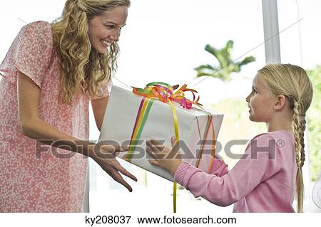 Girl giving present to her mother View Large Photo Image Stock Photo - Girl giving present to her mother. Fotosearch