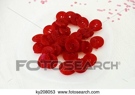 Pile of red spiral candies on a table View Large Photo Image Stock Image - Pile of red spiral candies on a table. Fotosearch
