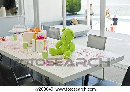 Stock Photo - Teddy bear and birthday presents on a table. Fotosearch