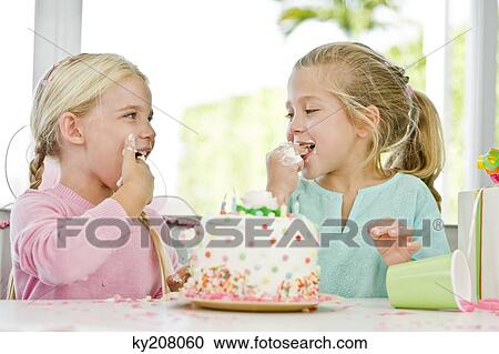 Two girls eating birthday cake View Large Photo Image Stock Image - Two girls eating birthday cake. Fotosearch