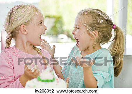 Two girls enjoying a birthday party View Large Photo Image Stock Image - Two girls enjoying a birthday party. Fotosearch