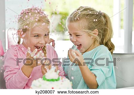 Two girls enjoying a birthday party View Large Photo Image Stock Photo - Two girls enjoying a birthday party. Fotosearch