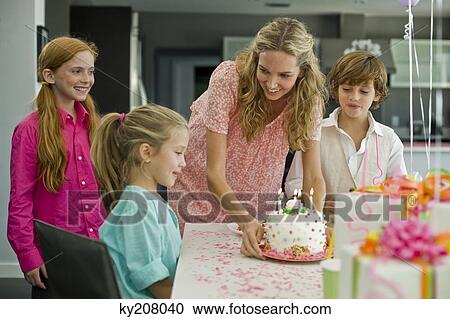 Stock Image - Woman celebrating her daughter's birthday. Fotosearch