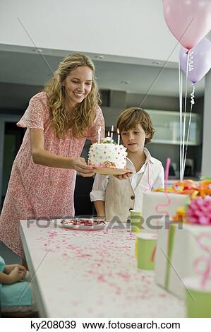 Woman holding a birthday cake View Large Photo Image Stock Photo - Woman holding a birthday cake. Fotosearch