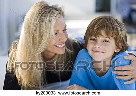 Close-up of a woman with her son View Large Photo Image Stock Image - Close-up of a woman with her son. Fotosearch