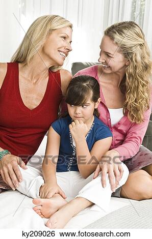 Stock Photograph - Family on the bed. Fotosearch
