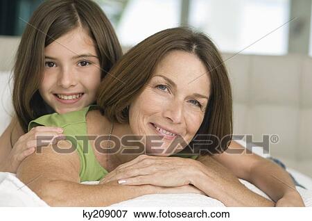 Portrait of a girl smiling with her grandmother View Large Photo Image Stock Photo - Portrait of a girl smiling with her grandmother. Fotosearch