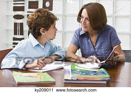 Woman helping her grandson in homework View Large Photo Image Stock Image - Woman helping her grandson in homework. Fotosearch
