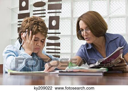 Woman helping her grandson in homework View Large Photo Image Stock Image - Woman helping her grandson in homework. Fotosearch