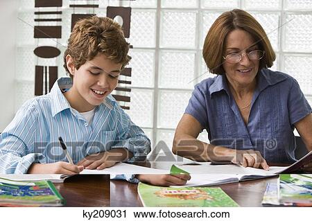 Woman helping her grandson in homework View Large Photo Image Stock Image - Woman helping her grandson in homework. Fotosearch