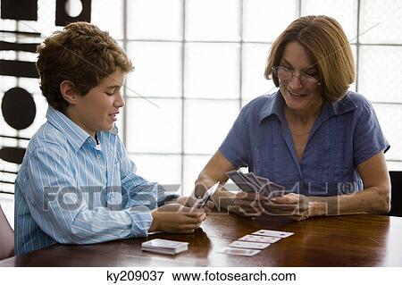 Woman playing cards with her grandson View Large Photo Image Stock Photo - Woman playing cards with her grandson. Fotosearch