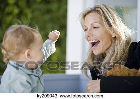 Woman playing with her son View Large Photo Image Stock Image - Woman playing with her son. Fotosearch