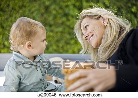 Woman playing with her son View Large Photo Image Stock Photograph - Woman playing with her son. Fotosearch