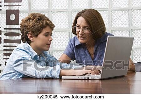 Woman teaching her grandson View Large Photo Image Stock Photography - Woman teaching her grandson. Fotosearch