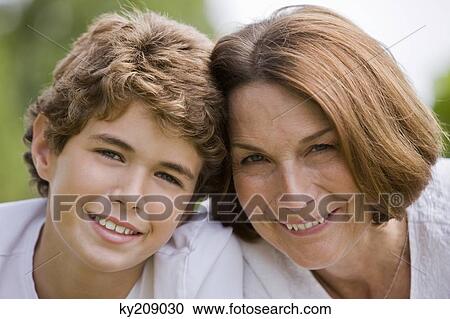 Woman with her grandson smiling View Large Photo Image Stock Image - Woman with her grandson smiling. Fotosearch