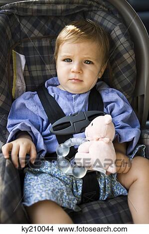 Baby boy sitting in a baby seat View Large Photo Image Picture - Baby boy sitting in a baby seat. Fotosearch