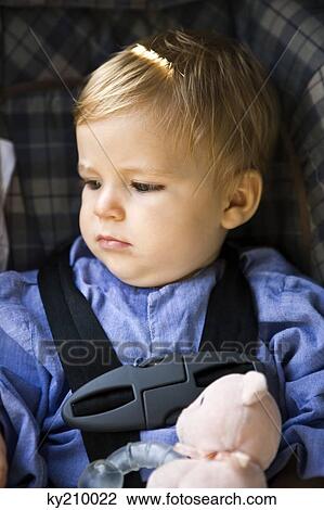 Baby boy sitting in a baby seat View Large Photo Image Stock Image - Baby boy sitting in a baby seat. Fotosearch
