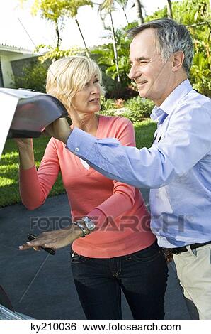 Couple holding a car trunk View Large Photo Image Stock Photograph - Couple holding a car trunk. Fotosearch
