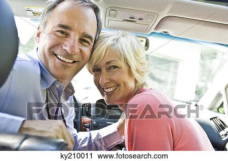 Couple in a car and smiling View Large Photo Image Stock Image - Couple in a car and smiling. Fotosearch