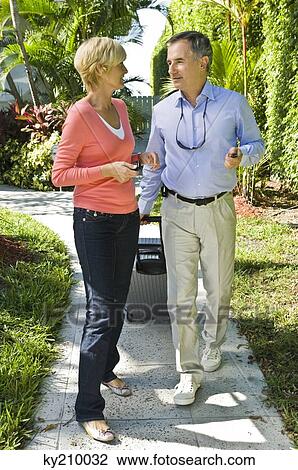 Couple looking at each other and walking View Large Photo Image Stock Image - Couple looking at each other and walking. Fotosearch